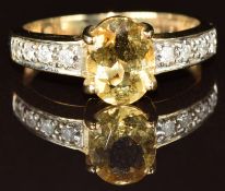 A 9k gold ring set with an oval cut yellow beryl of approximately 1ct and diamonds, 3.3g, size Q
