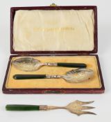 Cased pair of New Zealand Greenstone handled silver jam spoons, marked to bowls sterling and with