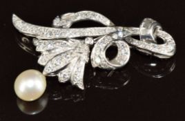 A platinum brooch set with round and baguette cut diamonds and a cultured pearl, 8g, 4cm