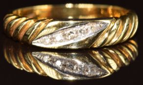 An 18ct gold ring set with five diamonds, with ridged decoration to the shoulders, 2.5g, size L