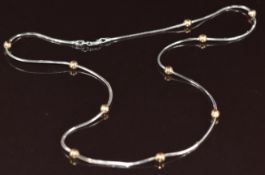 A 9ct white gold necklace with 9ct yellow gold sphere decoration, 7.2g, 42cm