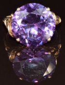A 14k gold ring set with a round cut synthetic purple sapphire, 6g, size O