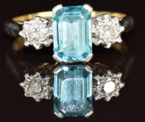 An 18ct gold ring set with an emerald cut topaz and two diamonds, 2.8g, size G