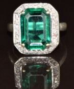 An 18ct white gold ring set with paste surrounded by diamonds, 10.3g, size M