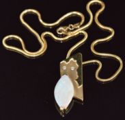 An 18k gold pendant set with a marquise cut opal and two diamonds in an abstract design (4.2cm),