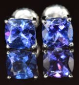 A pair of platinum earrings each set with a cushion cut tanzanite of approximately 1ct, 2.8g