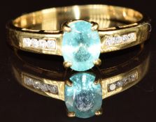 An 18k gold ring set with an oval cut Paraiba tourmaline and diamonds, 2.5g, size Q