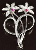 An 18ct white gold brooch in the form of two flowers set with rubies and diamonds, Edinburgh 1965,