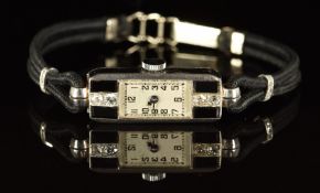 Art Deco platinum ladies wristwatch with 0.06ct of old cut diamonds and onyx set to the case,
