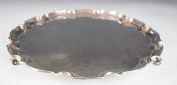 George VI hallmarked silver salver with shaped edge, raised on three scroll feel, Birmingham 1938,