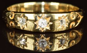 An 18ct gold ring set with three old cut diamonds in a star setting, 2.7g, size K