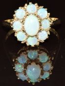 A 9ct gold ring set with a cluster of opals, 3.4g, size R