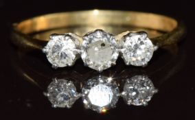 An 18ct gold ring set with three round cut diamonds, the largest approximately 0.3ct, size R/S