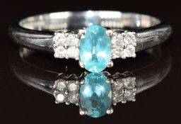A 9k white gold ring set with an oval cut apatite and diamonds, 2.5g, size Q