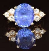 An 18ct gold ring set with an oval cut tanzanite of approximately 5ct and three round cut diamonds