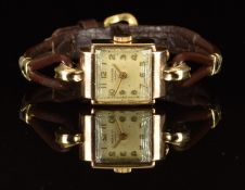 J W Benson 9ct gold ladies wristwatch with gold hands and Arabic numerals, silver dial and signed 15