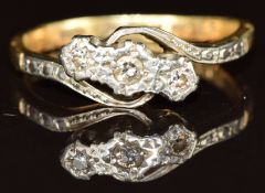An 18ct gold ring set with three diamonds in a platinum twist setting, 2.8g, size L