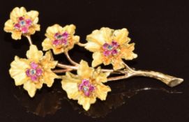 An 18k gold brooch in the form of flowers set with sapphires and rubies, 11.5g, 5cm