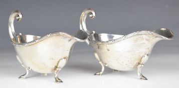 Art Deco pair of hallmarked silver gravy or sauce boats with decorative edges and scroll handles,