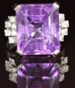 An 18k white gold ring set with an emerald cut amethyst of approximately 22ct and diamonds to the