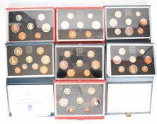 Seven Royal Mint proof coin collections in deluxe cases, some with certificates, includes 1980s