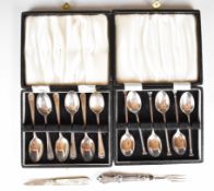 Two cased sets of hallmarked silver coffee bean spoons, one with shell decoration to handles, both