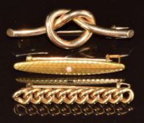 Edwardian 9ct gold love knot brooch, 9ct gold curb link brooch (7g) and a c1920 yellow metal