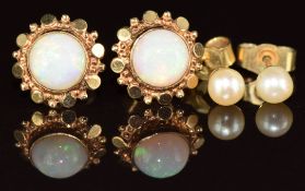 A pair of 9ct gold earrings each set with an opal cabochon and a pair of 9ct gold earrings each