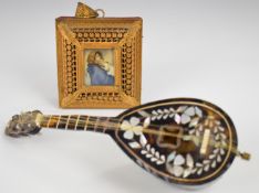 Two novelty musical boxes, one in the form of a portrait miniature the other a mandolin, length