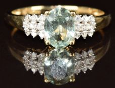 A 9ct gold ring set with an oval cut aquamarine of approximately 1ct and diamonds, 1.9g, size Q