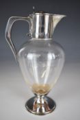 Edward VII hallmarked silver mounted glass claret jug with hinged lid engraved with crest for the