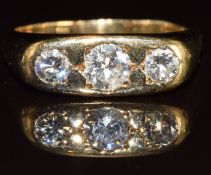 An 18ct gold ring set with three round cut diamonds of approximately 0.5ct, 0.25ct and 0.25ct, 10.