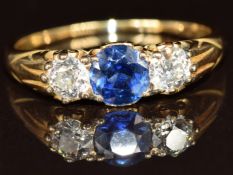 An 18ct gold ring set with a round cut sapphire of approximately 0.7ct and old cut diamonds, each