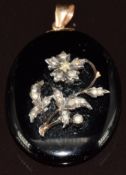 Victorian enamel locket set with seed pearls in the form, of a flower verso a locket compartment,