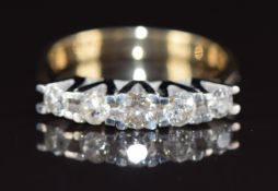 An 18ct gold ring set with five diamonds, the largest approximately 0.21ct, 5.0g, size P