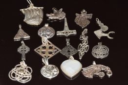 Sixteen silver pendants including Celtic examples, 150g