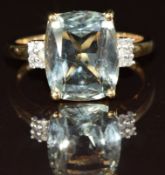 A 9ct gold ring set with a mixed cut aquamarine and diamonds, 3.4g, size P