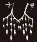 A pair of 18ct white gold earrings set with diamonds, the total diamond weight 1.3ct, 8.6g, 5.2cm