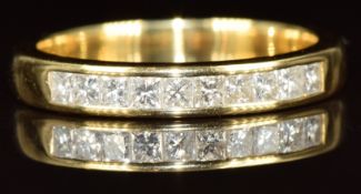 An 18ct gold half eternity ring set with ten princess cut diamonds, the total diamond weight
