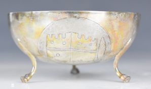 Two Continental silver bowls, both with embossed decoration, raised on three feet and marked 800,
