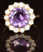 A 14k gold ring set with a round cut synthetic purple sapphire surrounded by white sapphires, 4.
