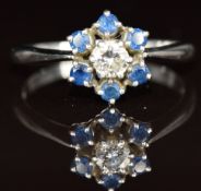 An 18ct white gold ring set with a round cut diamond of approximately 0.17ct surrounded by