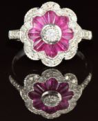 An 18ct white gold ring set with tapered baguette cut rubies and diamonds in a cluster, 4.2g, size N