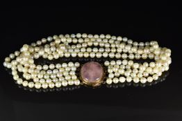 A five strand pearl necklace with 14k gold oval clasp set with a rose quartz cabochon, 132g, 42cm