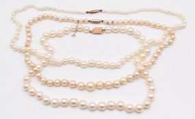 Three strands of cultured pearls with 9ct gold clasps, longest 48cm