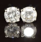 A pair of 9ct white gold earrings each set with a diamond of approximately 0.25ct, 0.6g