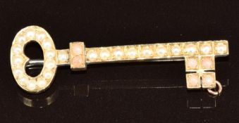 A c1910 15ct gold brooch in the form of a key set with coral and pearls, 3.9g, 4.2cm