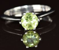 A 9k white gold ring set with a round cut peridot of approximately 0.8ct, 2.3g, size N
