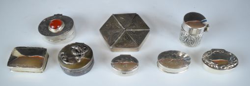 Eight white metal pill and similar pots including a hexagonal example with hinged lids, one with