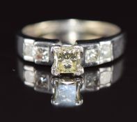 A 14ct gold ring set with a princess cut diamond of approximately 0.6ct and four further princess